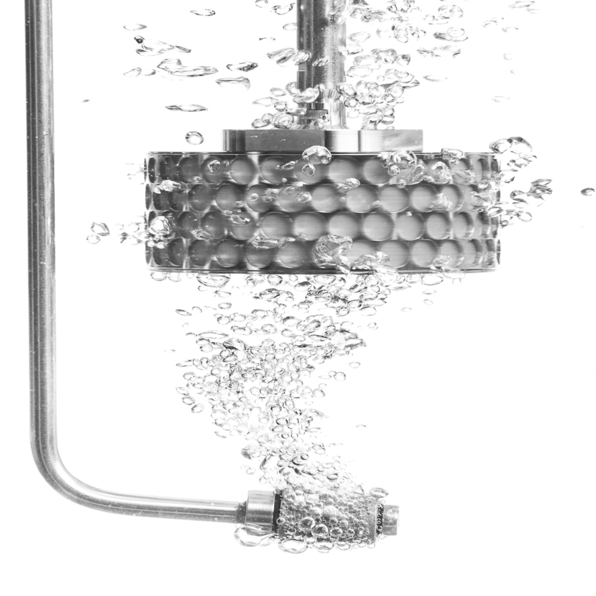 Close-up view of a stainless steel SpinChem gas sparger featuring a cylindrical perforated chamber with honeycomb-pattern holes, mounted on a curved inlet pipe and vertical shaft, designed for optimal gas-liquid mixing in laboratory reactions.