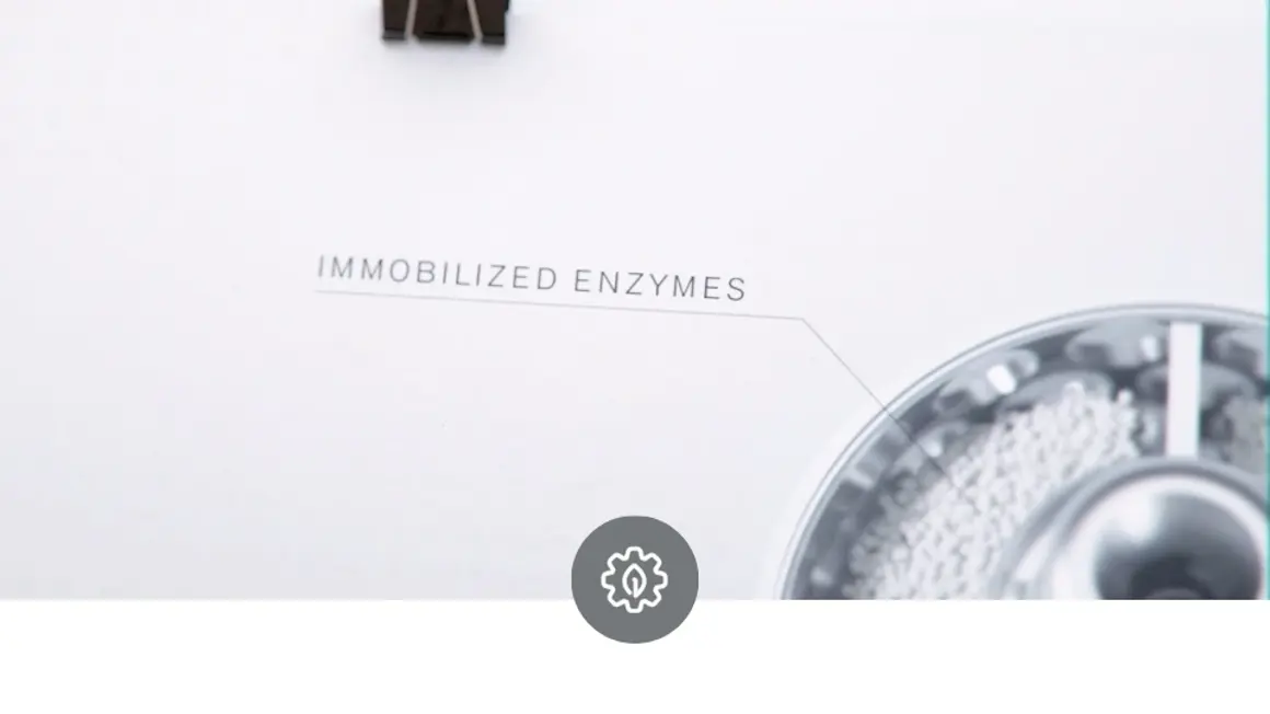 A rotating bed reactor animated design demonstrating contained solid phase and an icon symbolizing biocatalysis, highlighting its role in accelerating chemical processes using enzymes and immobilized catalysts.